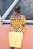 Colorful African print blouse and yellow skirt